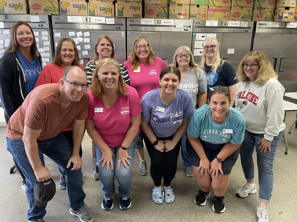 Members served food at the Partners for our Communities Food Pantry