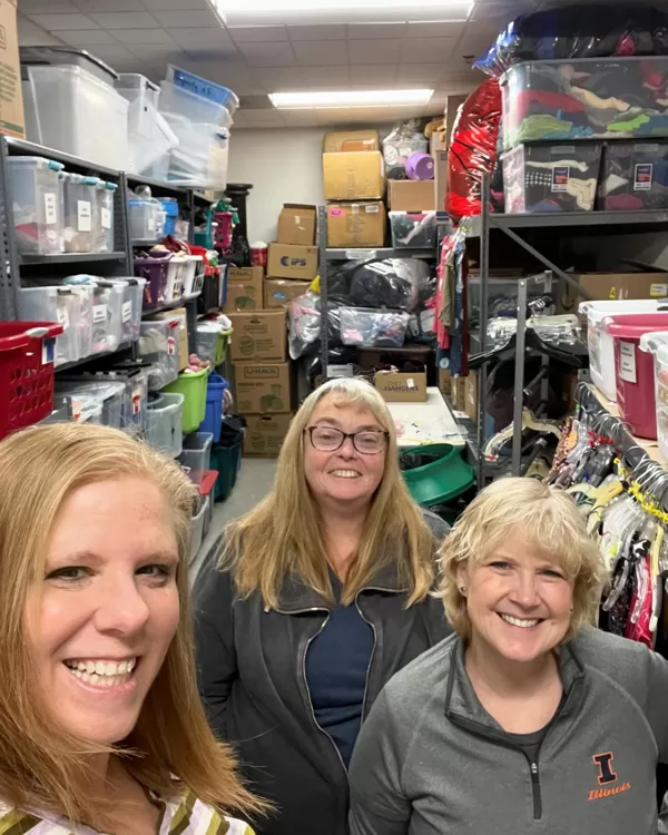 Sorting and hanging clothing for people in need at the POC